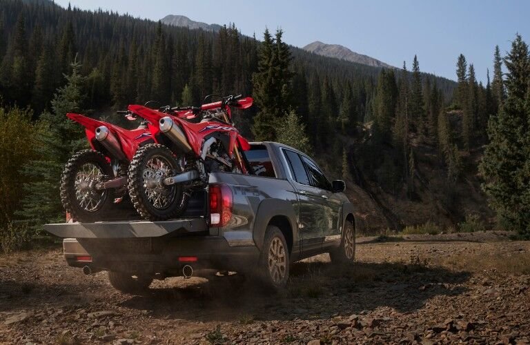 A photo of the 2021 Honda Ridgeline with dirtbikes in the back.