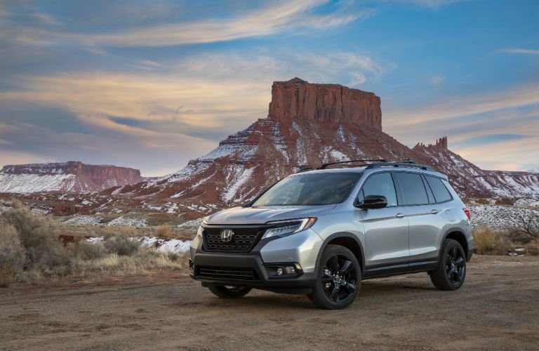 A photo of the Honda Passport parked in the desert.